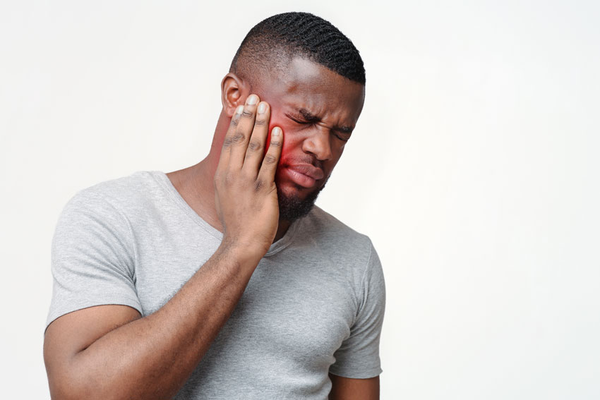 adult man holding his mouth in pain