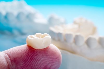 an example of a dental crown on a finger to show scale