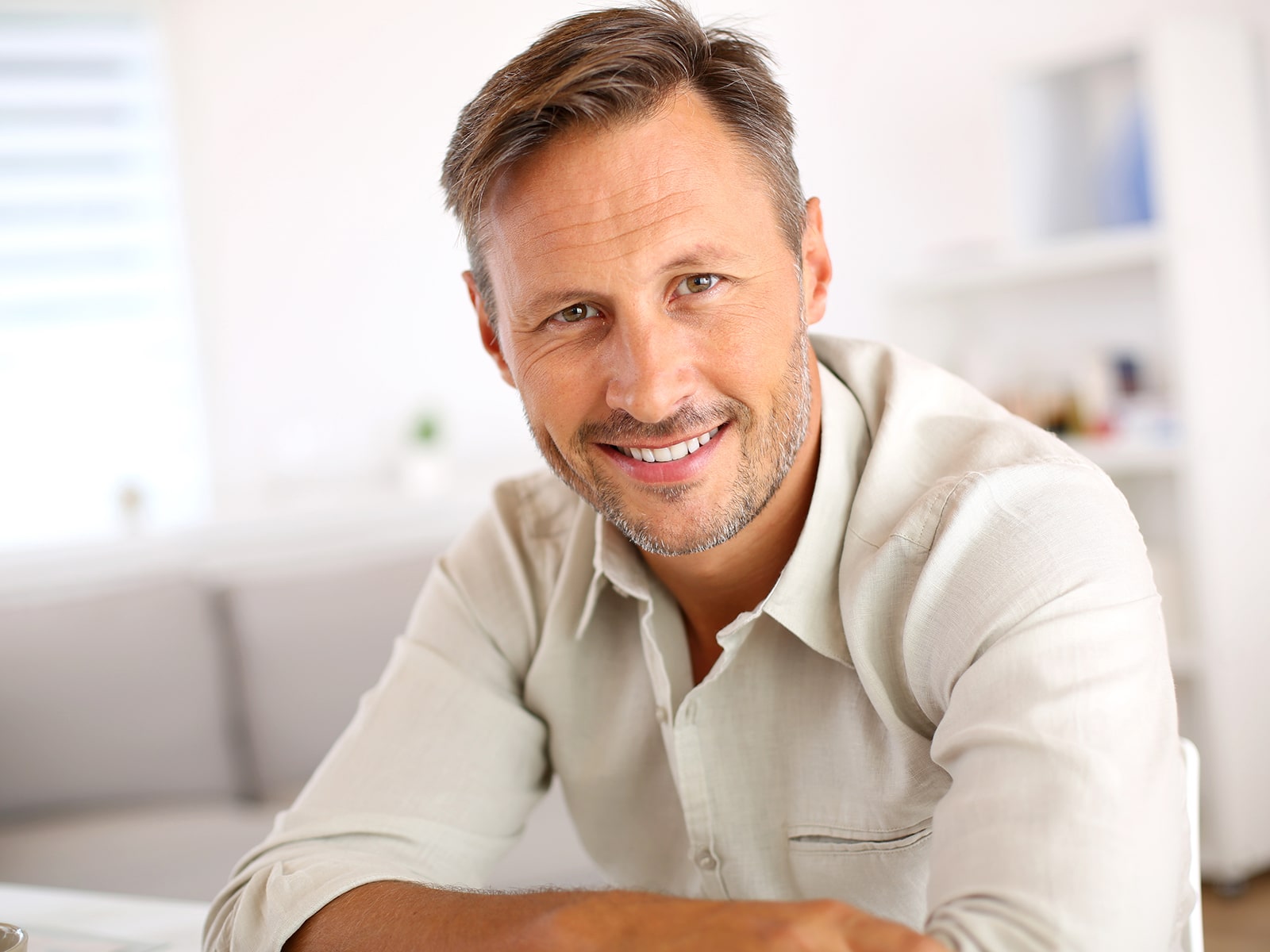 Man smiling leaning on elbows